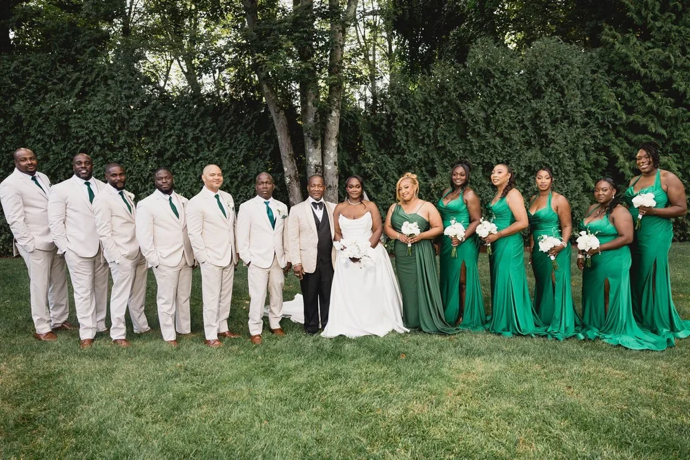Avenir wedding photographer, Walpole, MA — wedding party lined up across the ceremony lawn with tall trees behind