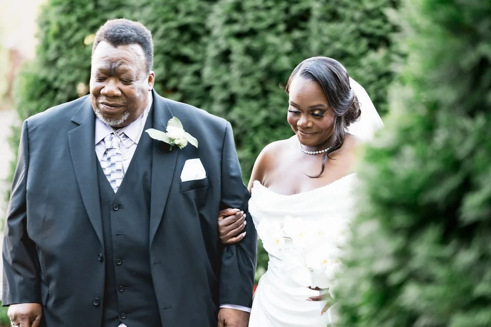 Avenir wedding videographer, Walpole, MA — bride walking down the garden aisle on the arm of an escort