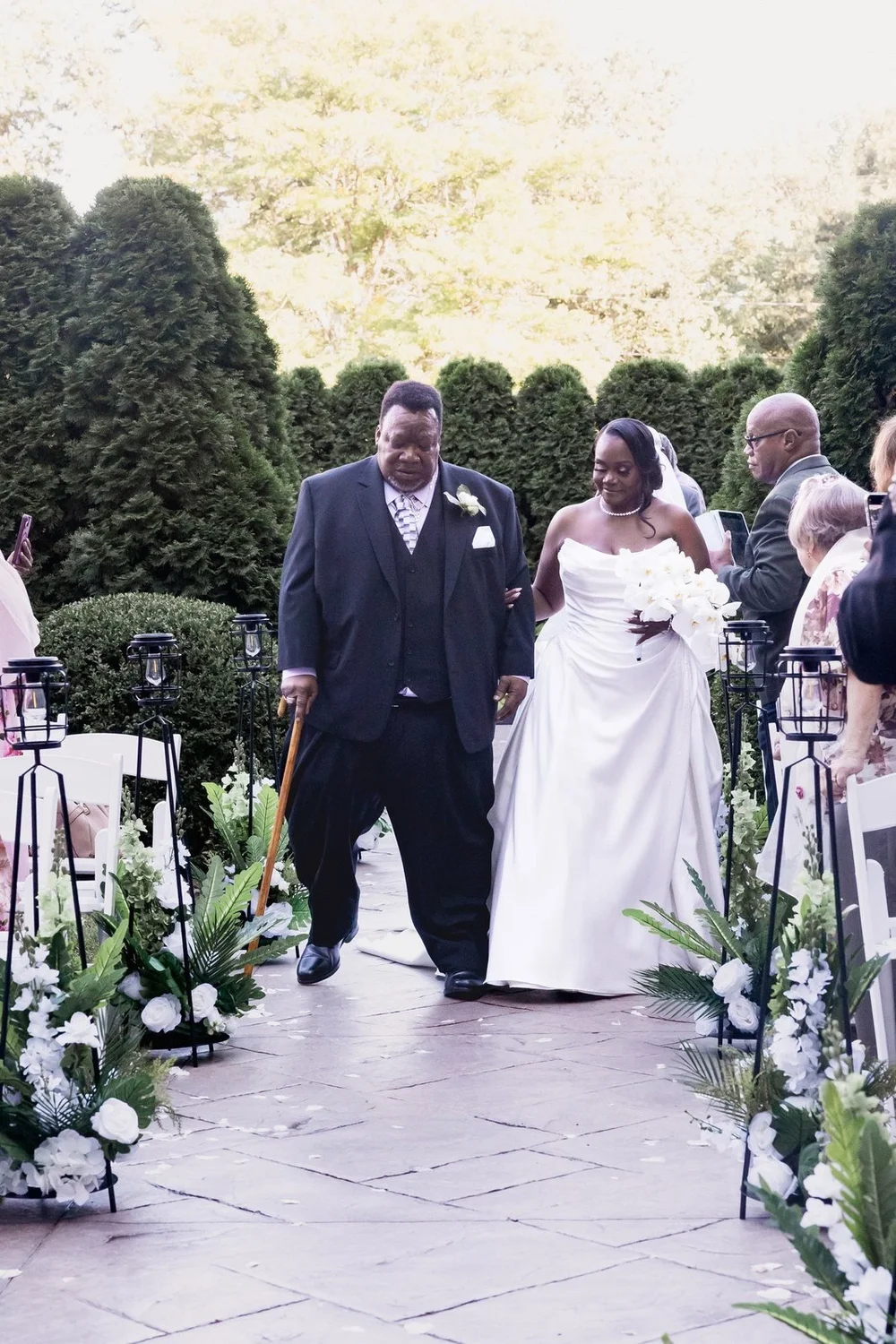 Avenir wedding videographer, Walpole, MA — newlyweds recessing up the garden aisle after their vows