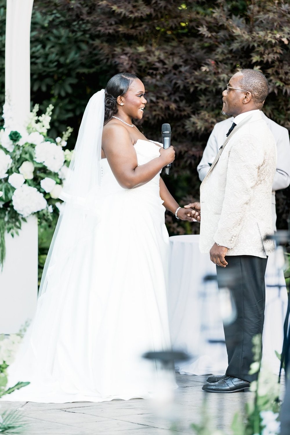 Avenir wedding videographer, Walpole, MA — bride holding the groom's hands as the officiant reads their vows