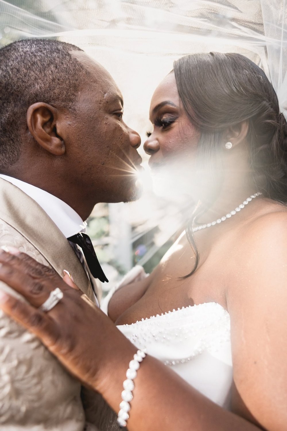 Avenir wedding videographer, Walpole, MA — groom and bride nose to nose beneath her veil in the garden