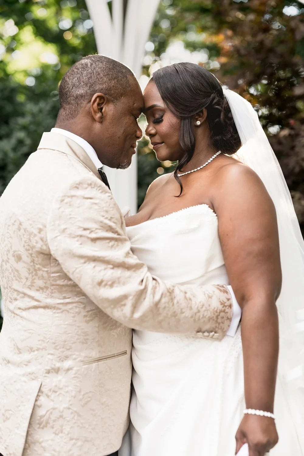 Avenir wedding photographer, Walpole, MA — bride smiling as the groom embraces her in the garden