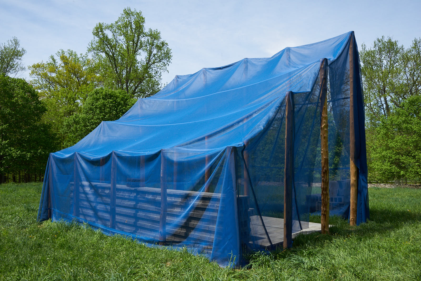Gabriela Salazar, Matters in Shelter (and Place, Puerto Rico) , 2018. Coffee clay (used coffee grounds, flour, salt), concrete block, wood, and polypropylene mesh tarp, 12 x 16 x 20 ft. Courtesy of the artist. Photo: Jerry L. Thompson.