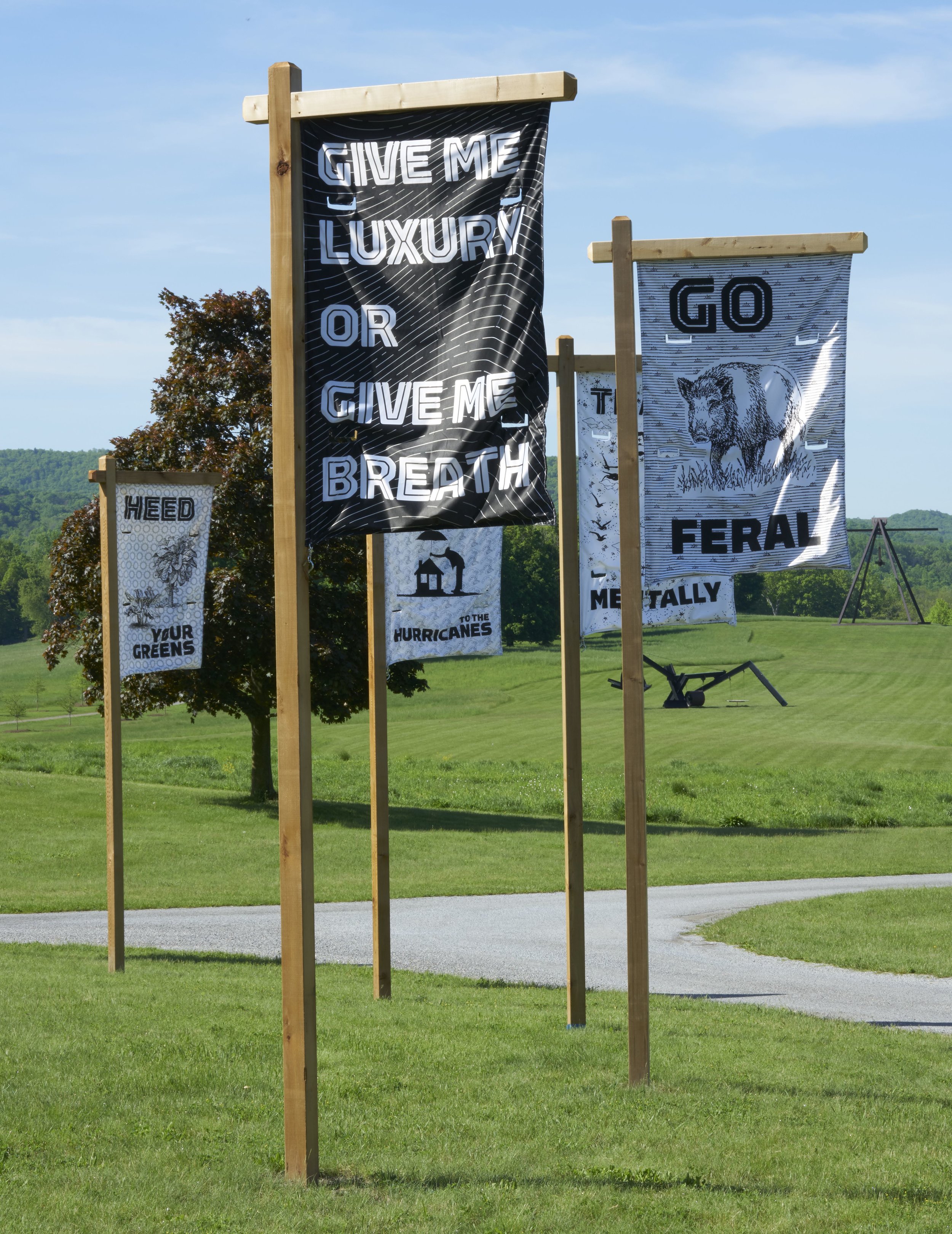 Dear Climate (U Chaudhuri, F Ertl, O Kellhammer, M Zurkow), General Assembly , 2018. Circle of nylon printed banners on wood poles, 12 ft. high, 84 ft. diam.; each flag 60 x 36 in. Courtesy of the artists. Photo: Jerry L. Thompson.