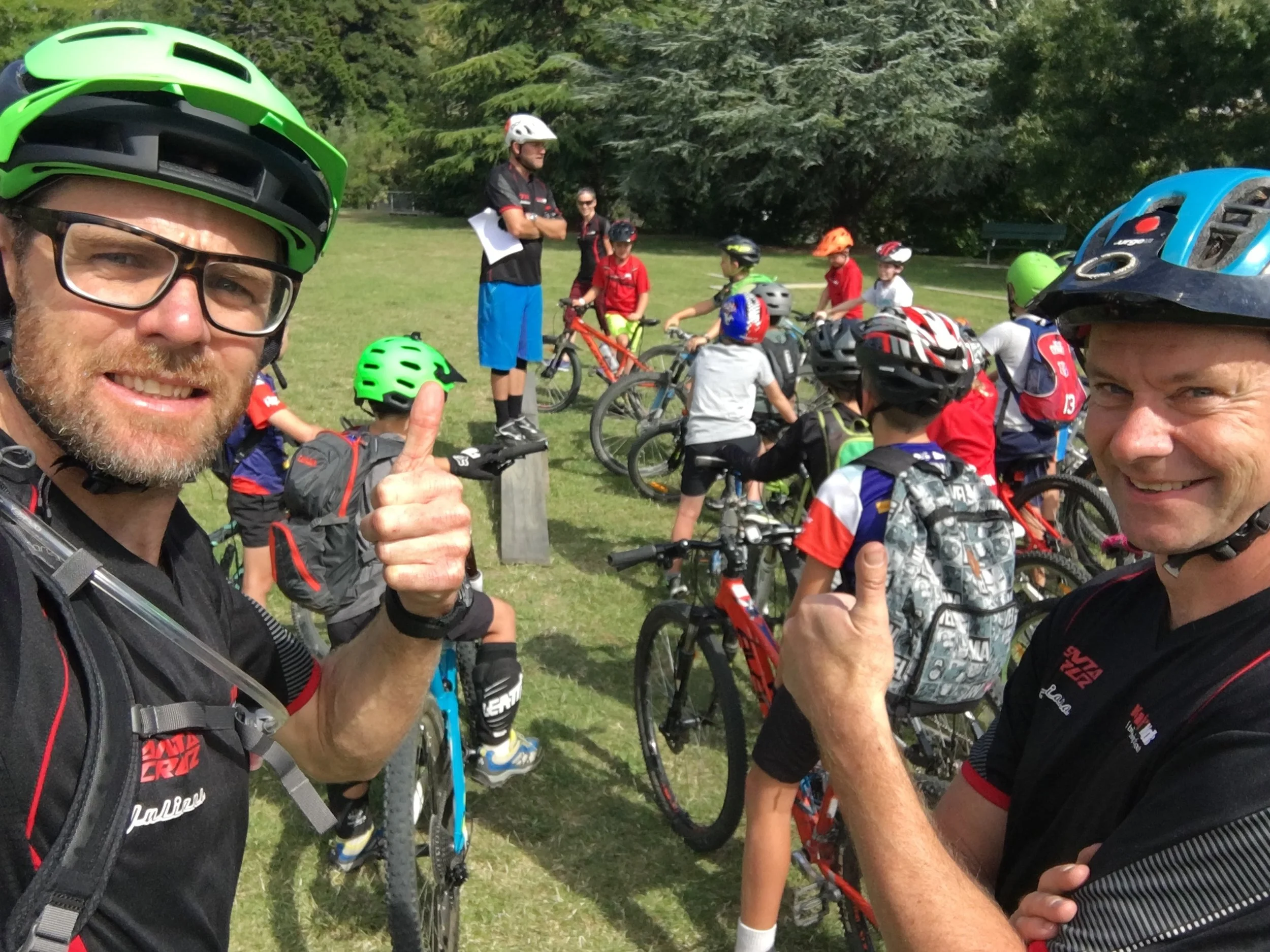 Coaches Damian Stones (mountain bike adventurer) and Mike Anderson (local bike shop owner) take a checkie selfie while Tay does roll call.