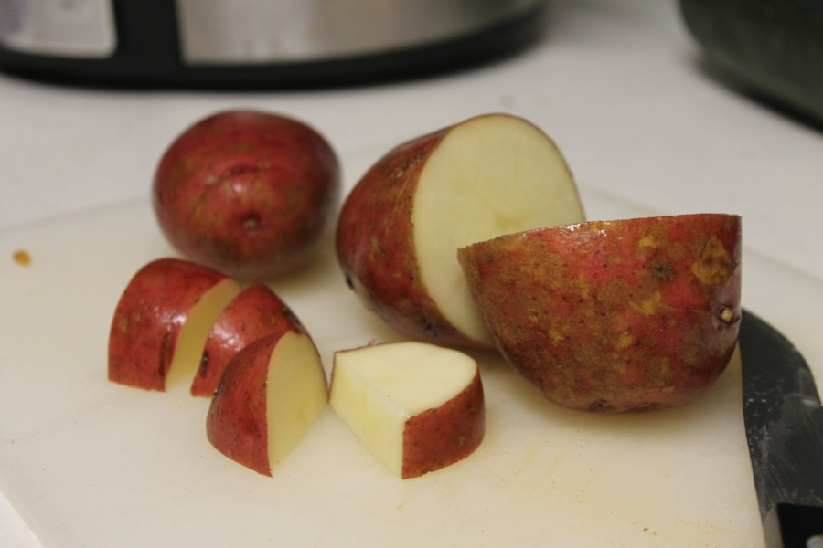 I have a love affair with red potatoes - there is no need to peel the skins off and they hold their integrity really well when slow cooked or baked. 