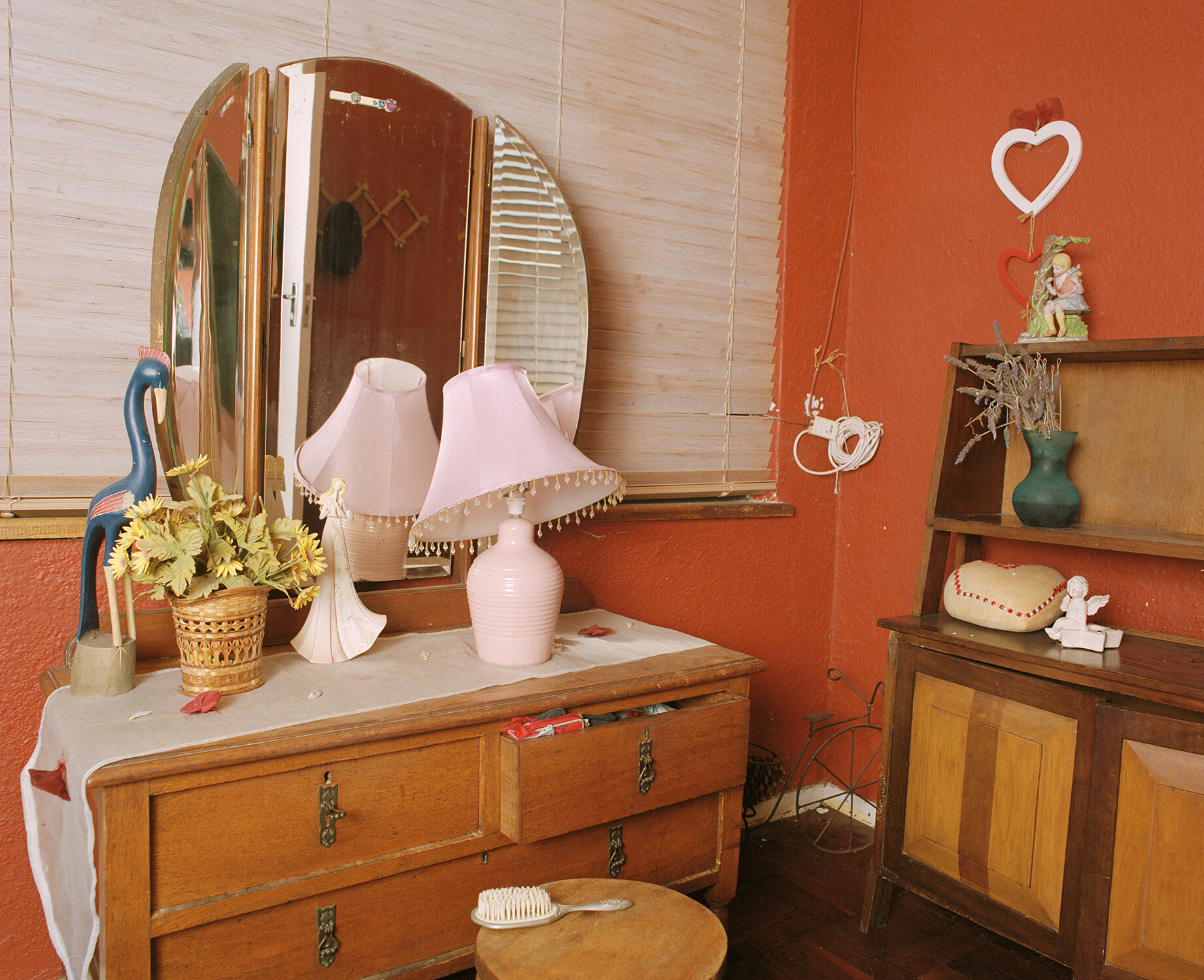  We Have To Leave  This dressing table is in Danwin Jaftha’s home in Milford Road, Plumstead. Danwin was raised by his aunt and uncle who lived in Strawberry Lane before being one of the last to be evicted in 1969 and moving to Lotus River. The image