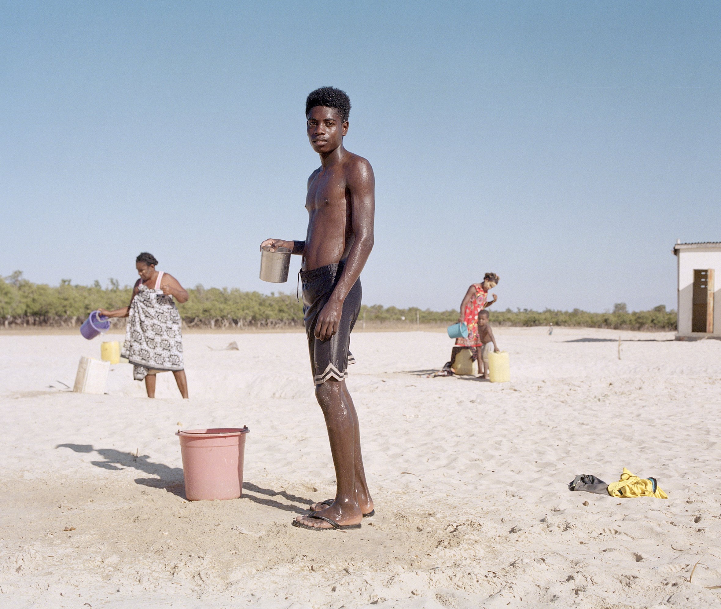  A teen boy washes salt off himself after a day of fishing, Madagascar  Part of a collection of images for WWF that form part of project on the communities that are safe guarding the precious mangroves of East &amp; Southern Africa.  