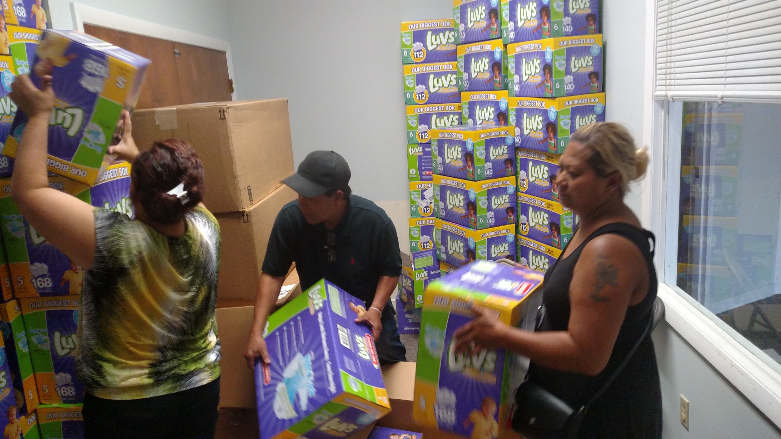 Volunteers help restock the Diaper Bank.