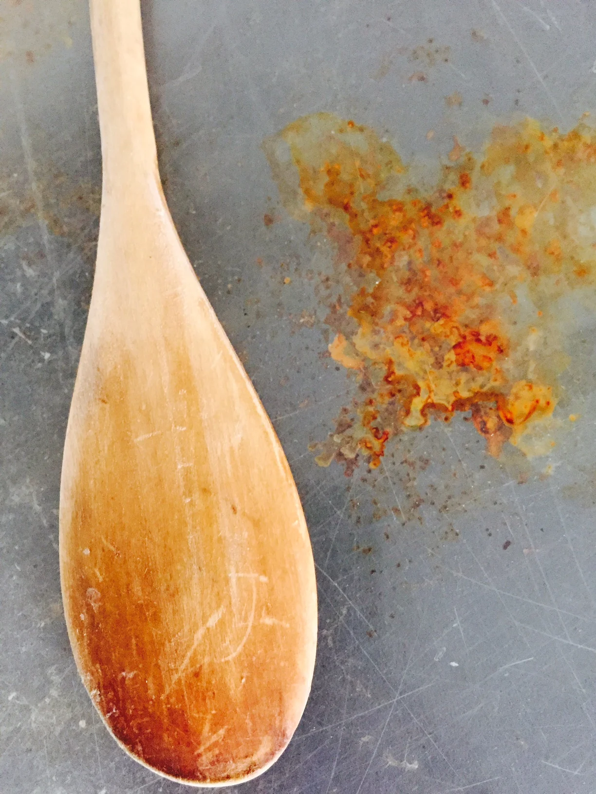 An ordinary wooden spoon becomes a beautiful part of an abstract composition. Rust and scratches never looked so good!
