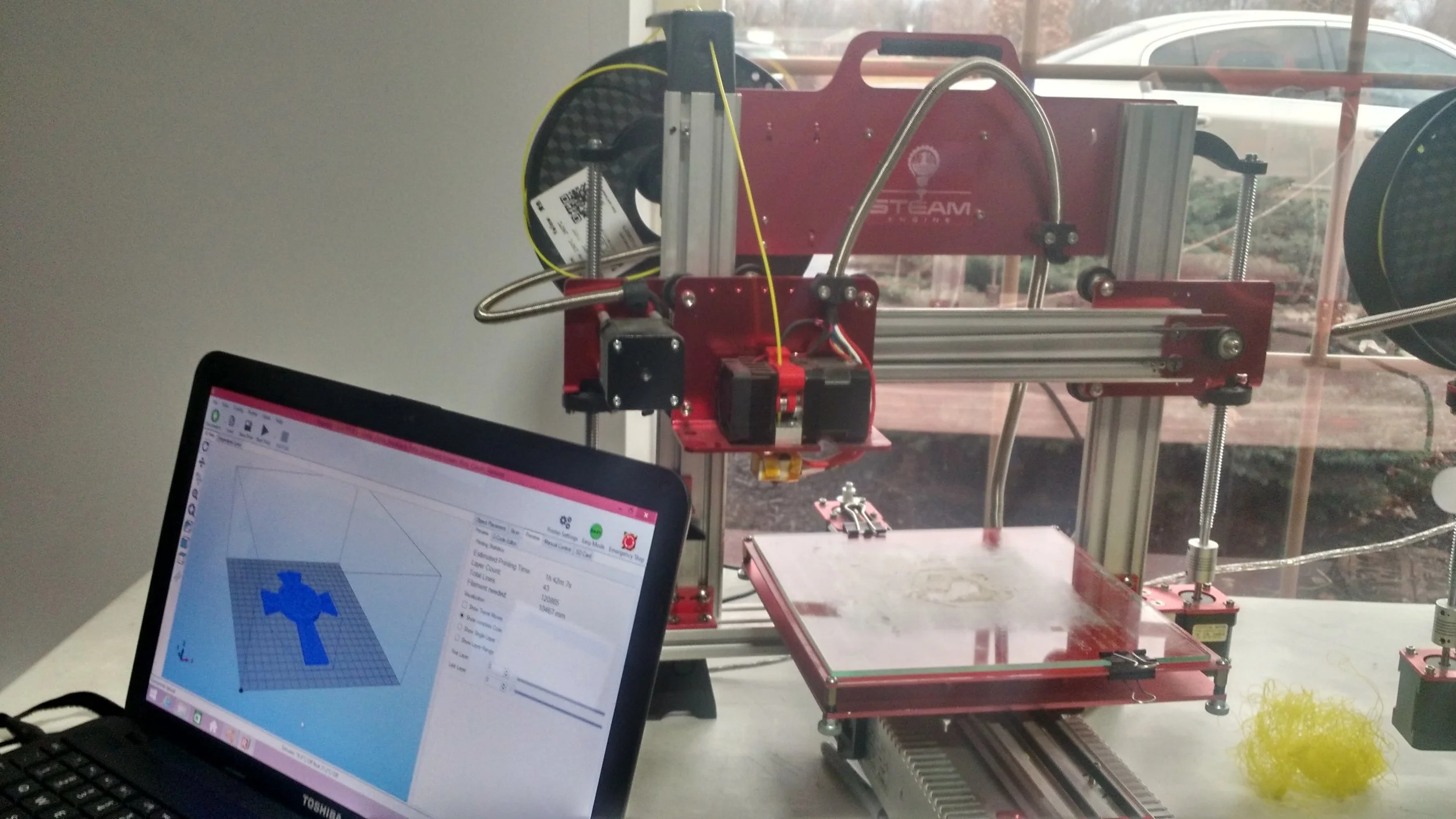 A 3D printer linked to computer design software.