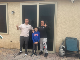 Family with their installed Boss security screen door