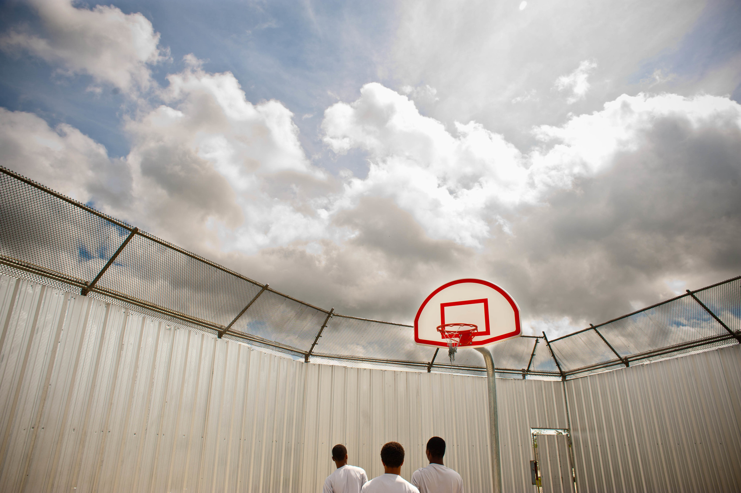    Teenage boys play basketball at the Youth Study Center juvenile detention facility in New Orleans, LA.  