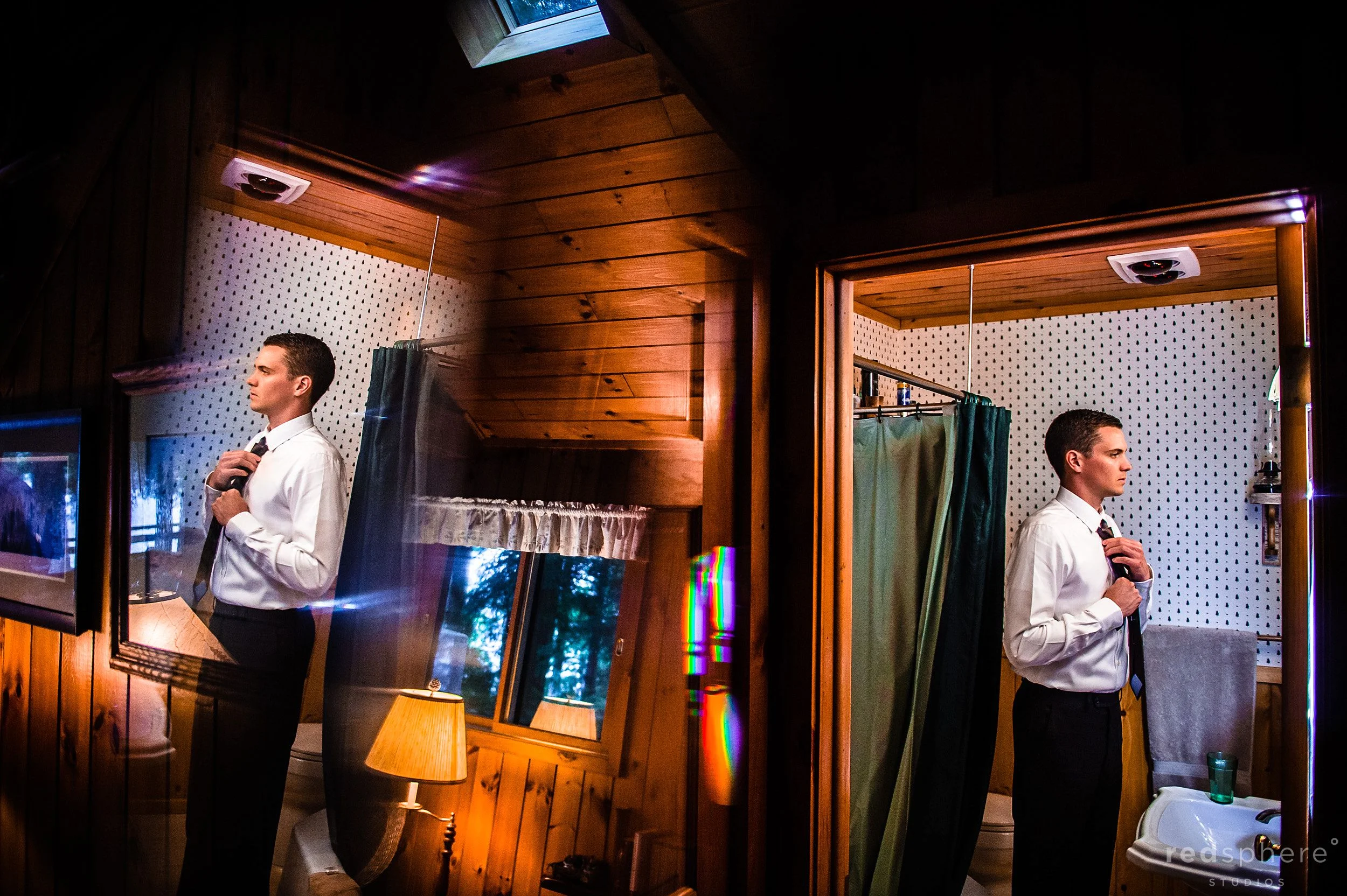 Groom Adjusting his tie in the Bathroom