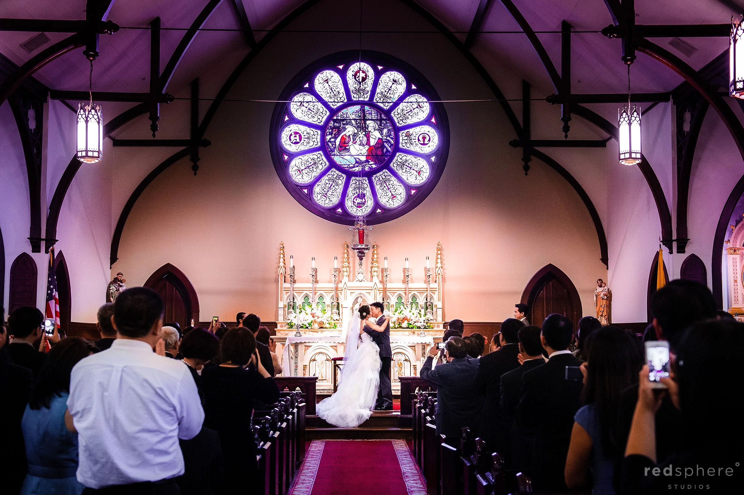 Bride and Groom Kiss, Aligned Aisle Shot, Church of the Nativity, Menlow Park, CA