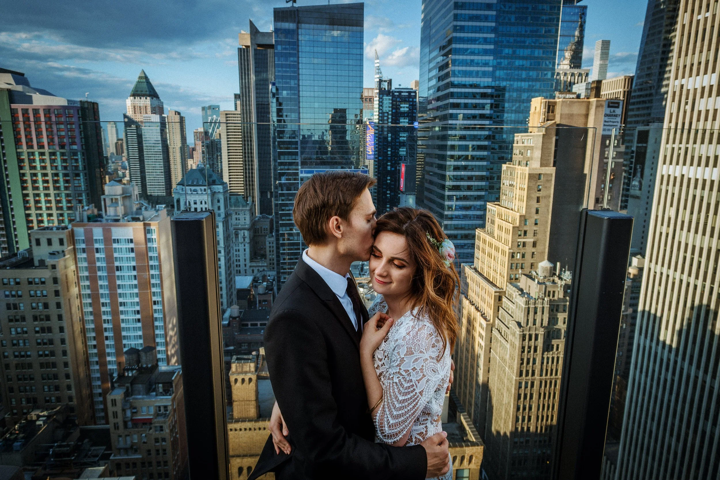 Engagement session on a rooftop observation deck overlooking New York City.