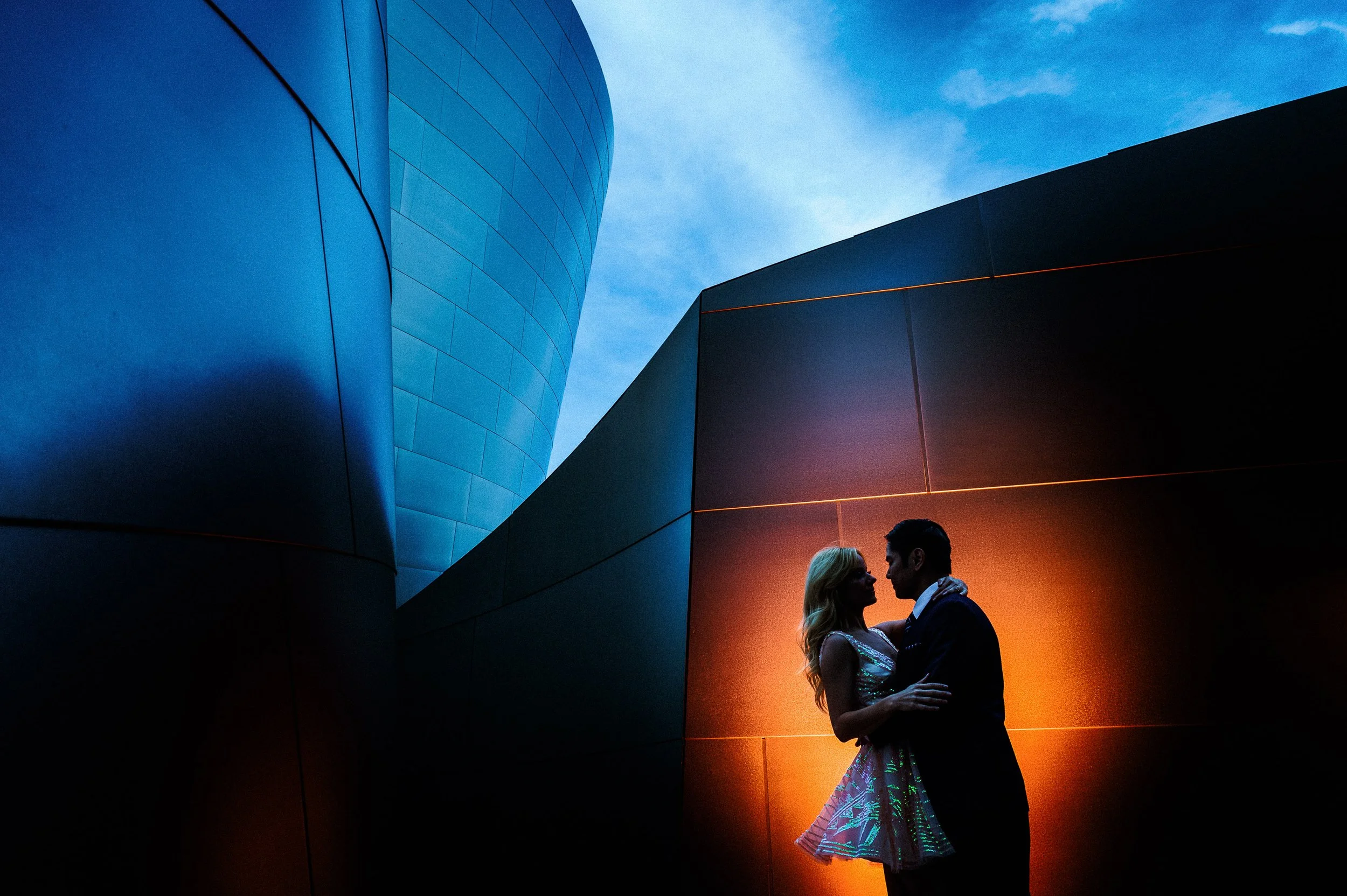 A couple stands close together during their engagement session at the Walt Disney Concert Hall in Los Angeles.