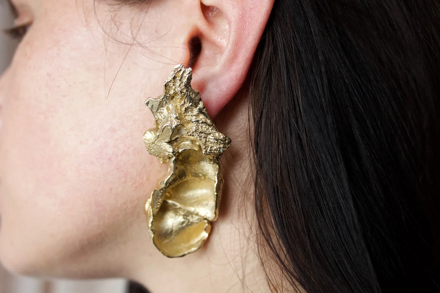  Paris Fontana,  ANNIHILATION  -  Inner Ear Barnacle,  2018, lost wax cast brass, 7.3 x 3.3 x 2.3cm. Model: Rachel Ciesla 