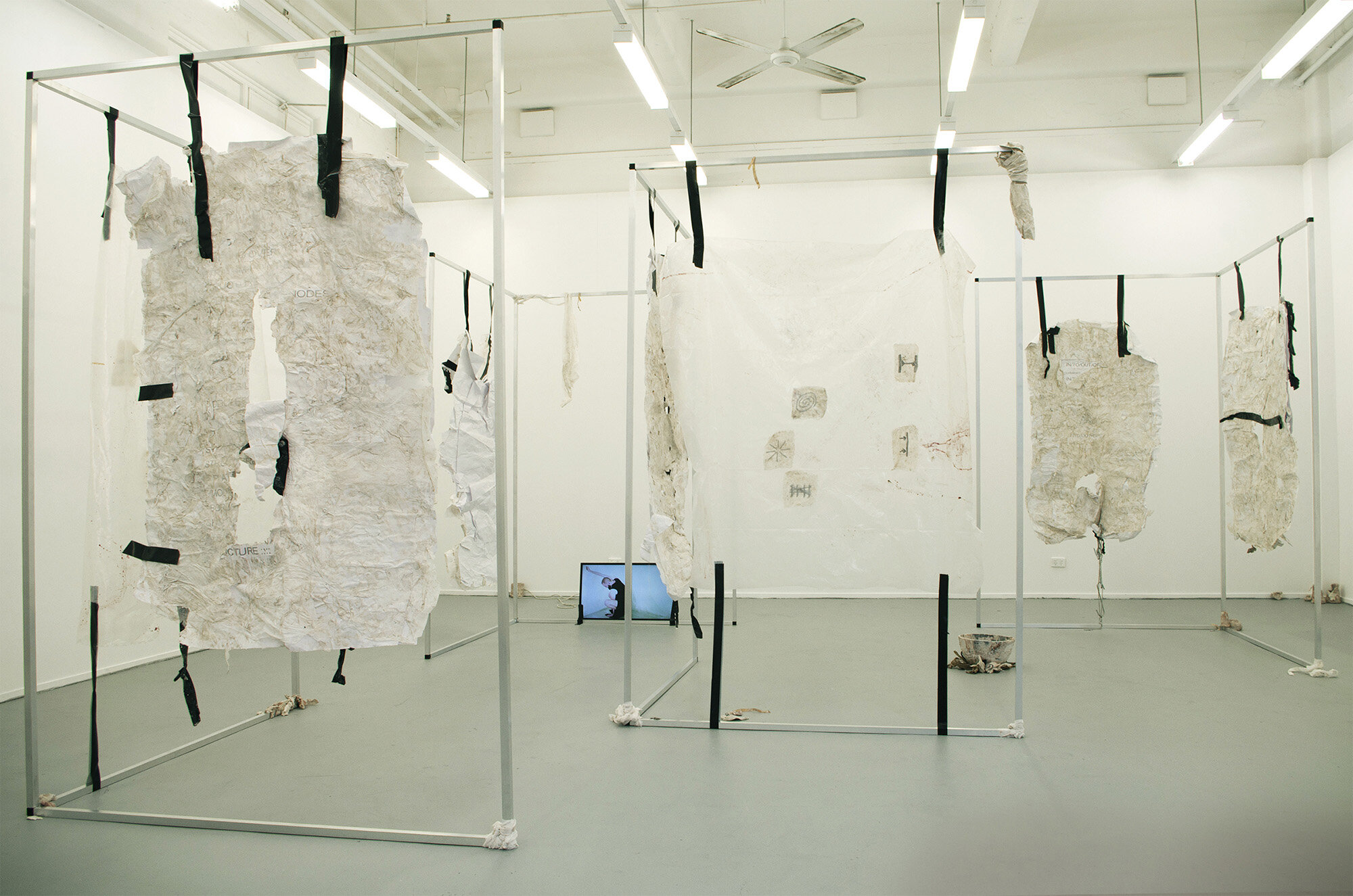                  Daniel R Marks,  GIVING MYSELF OVER , 2019. Installation (aluminium frames, digital prints on cartridge paper and fabric, plastic bowl, rusted steel beams, tape, tissue paper, fabric strips, latex, plasticine, clay, acrylic, glue, ce