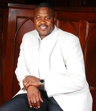 Copy of Pastor white jacket in front of pulpit.jpg