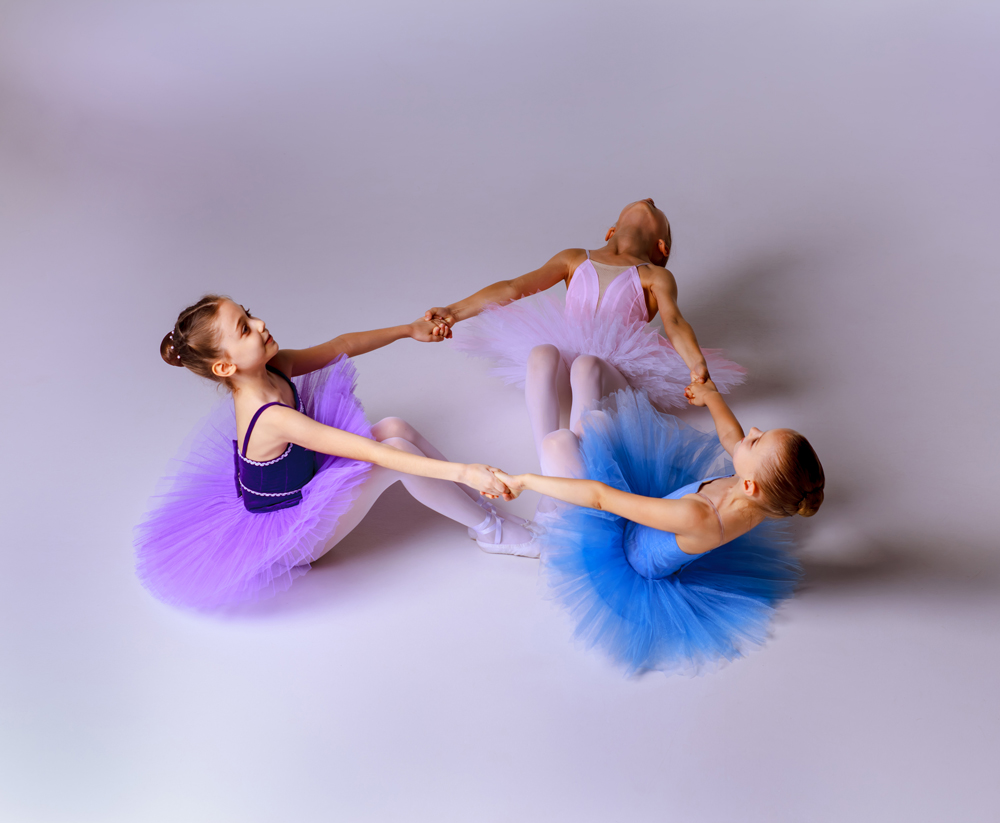 stockfresh_6380155_three-little-ballet-girls-sitting-in-tutu-and-posing-together_sizeL.jpg