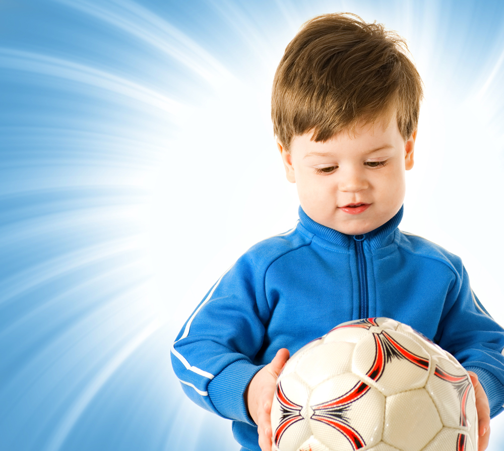 stockfresh_4361881_handsome-boy-with-soccer-ball-over-abstract-blue-background_sizeL.jpg