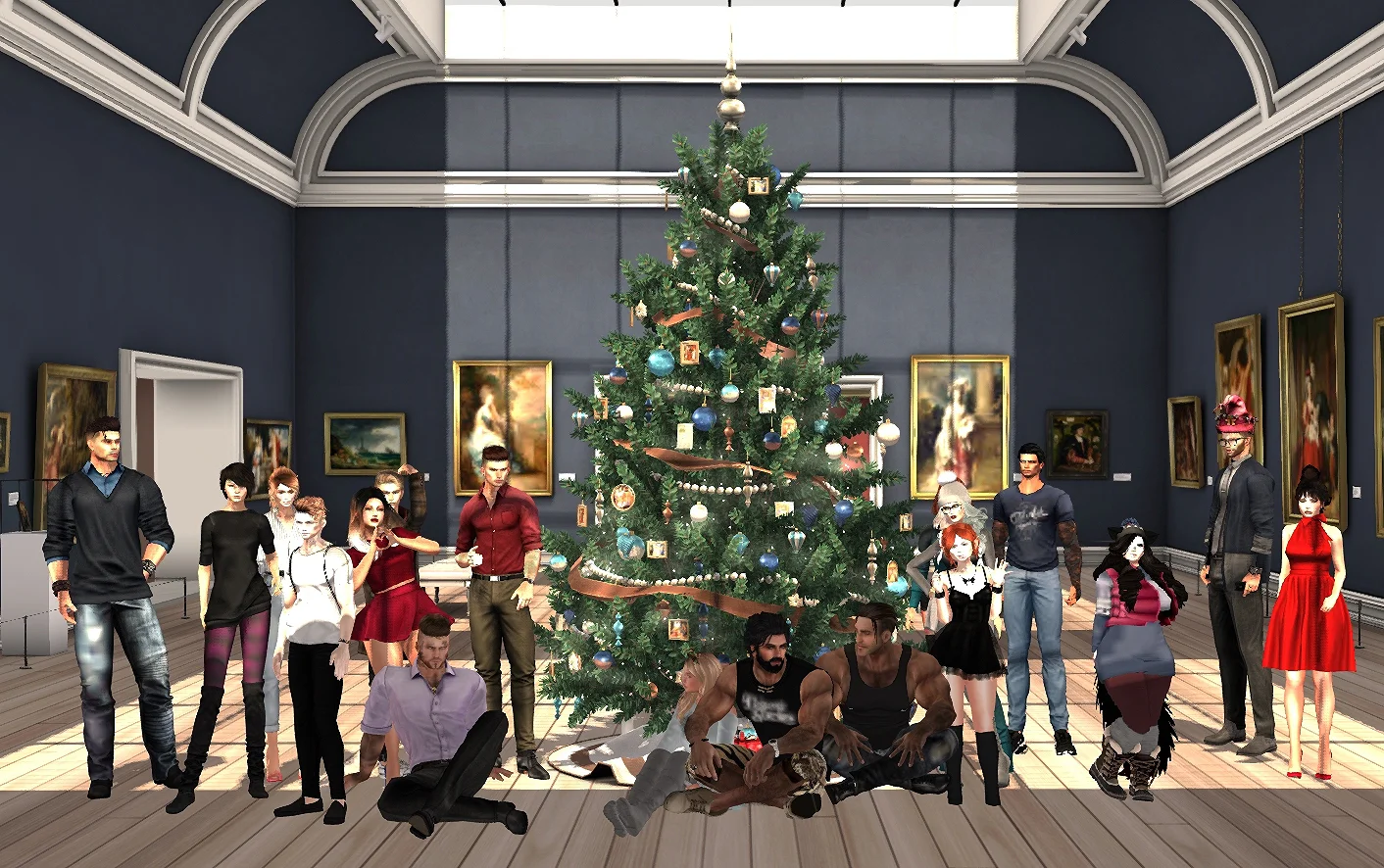 A group photo at the end of the even with the fully-decorated Christmas tree. 