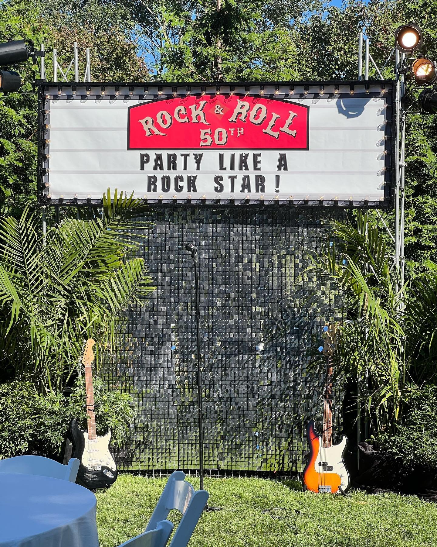 This 50th birthday party we decorated this weekend totally rocked! As usual our team brought the theme of vinyl and classic rock to every element of the event. 
Some of our favorite parts were the awesome photo backdrop with an incredible wig bar, vi