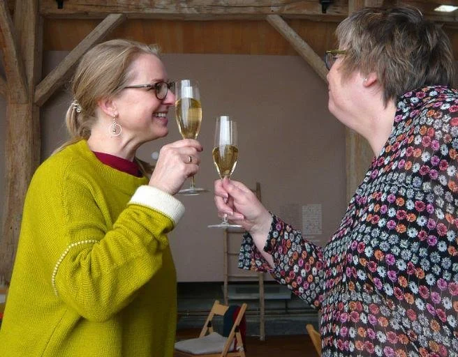 Participants sharing a drink during a residential creative retreat