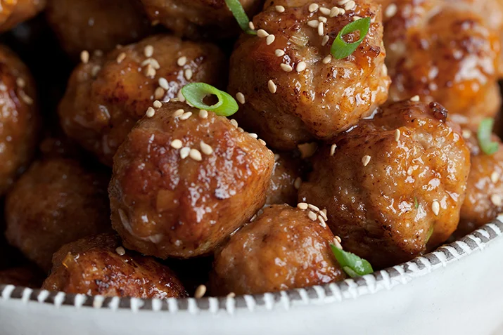 Spice up your next gathering with these amazing meatballs. Try them as an appetizer, made into sliders or atop rice.