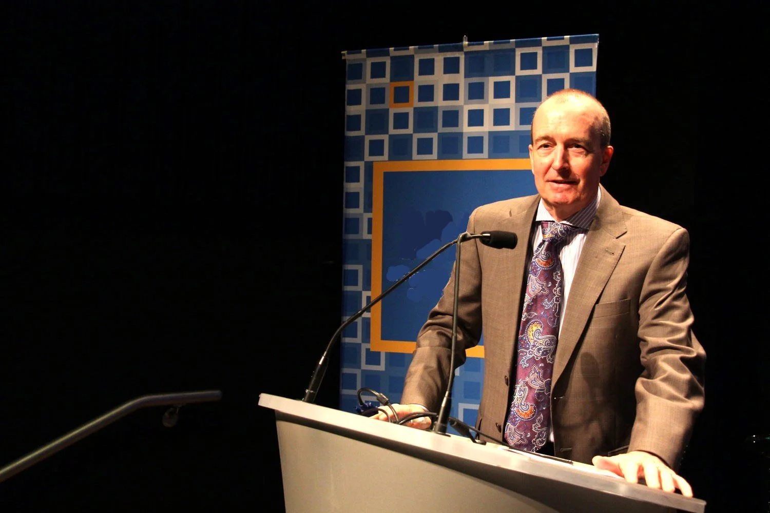 dr patrick love speaking at podium