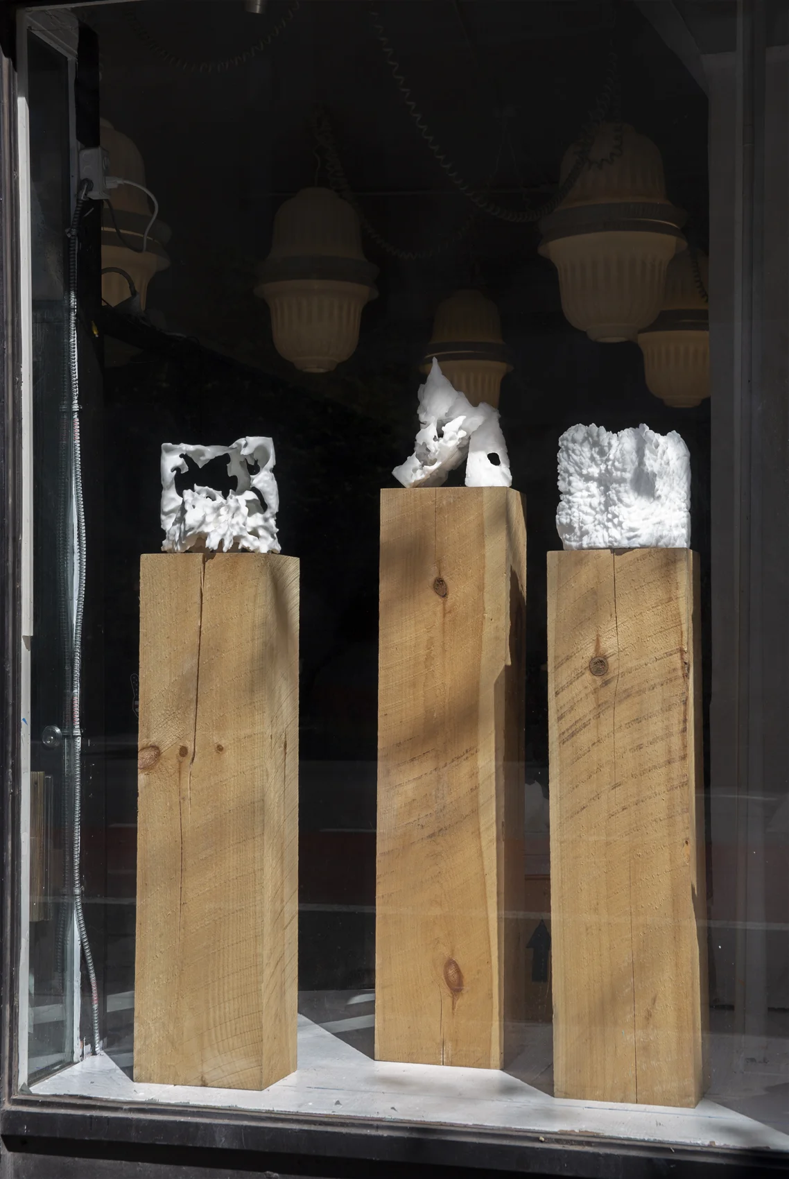 From left: Collapse Monolith, Support Monolith, and Cut Monolith, 2017—2018. Salt on rough hewn pine