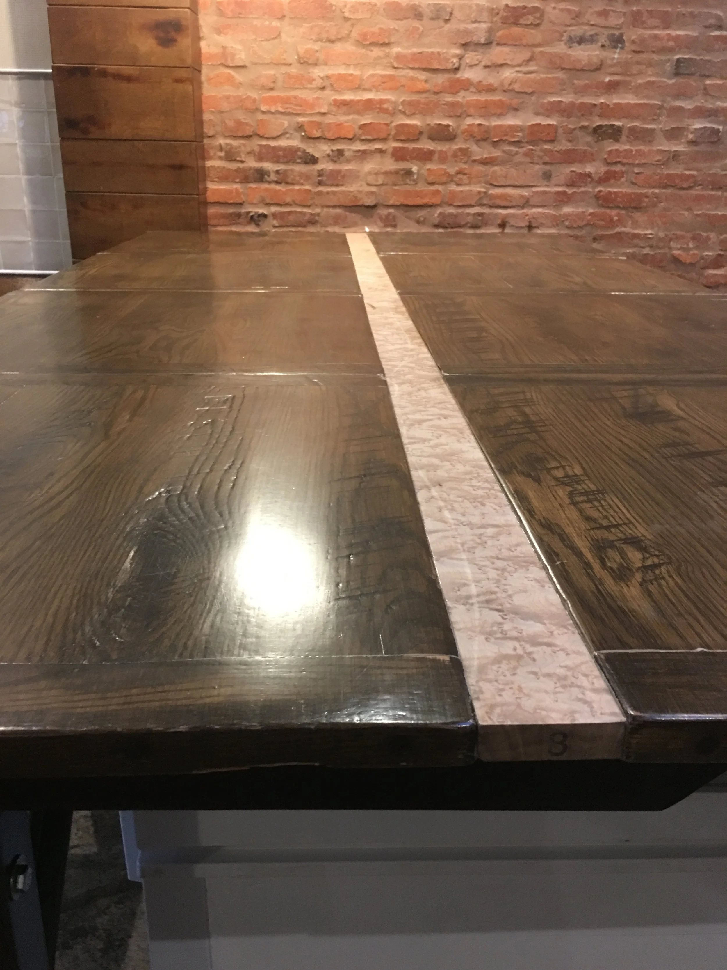 The surface itsself is made from oak tabletops reclaimed from the previous restaraunt on site. The dark oak of these is offset by a light strip of figured bird's eye maple that I had been saving for the right project to come along.