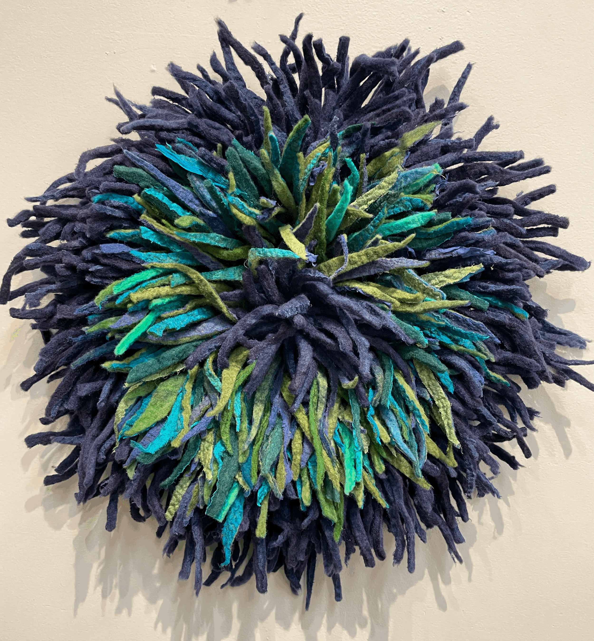 Shag Anemone Wallhanging shades of purple, teal, turquoise and green.