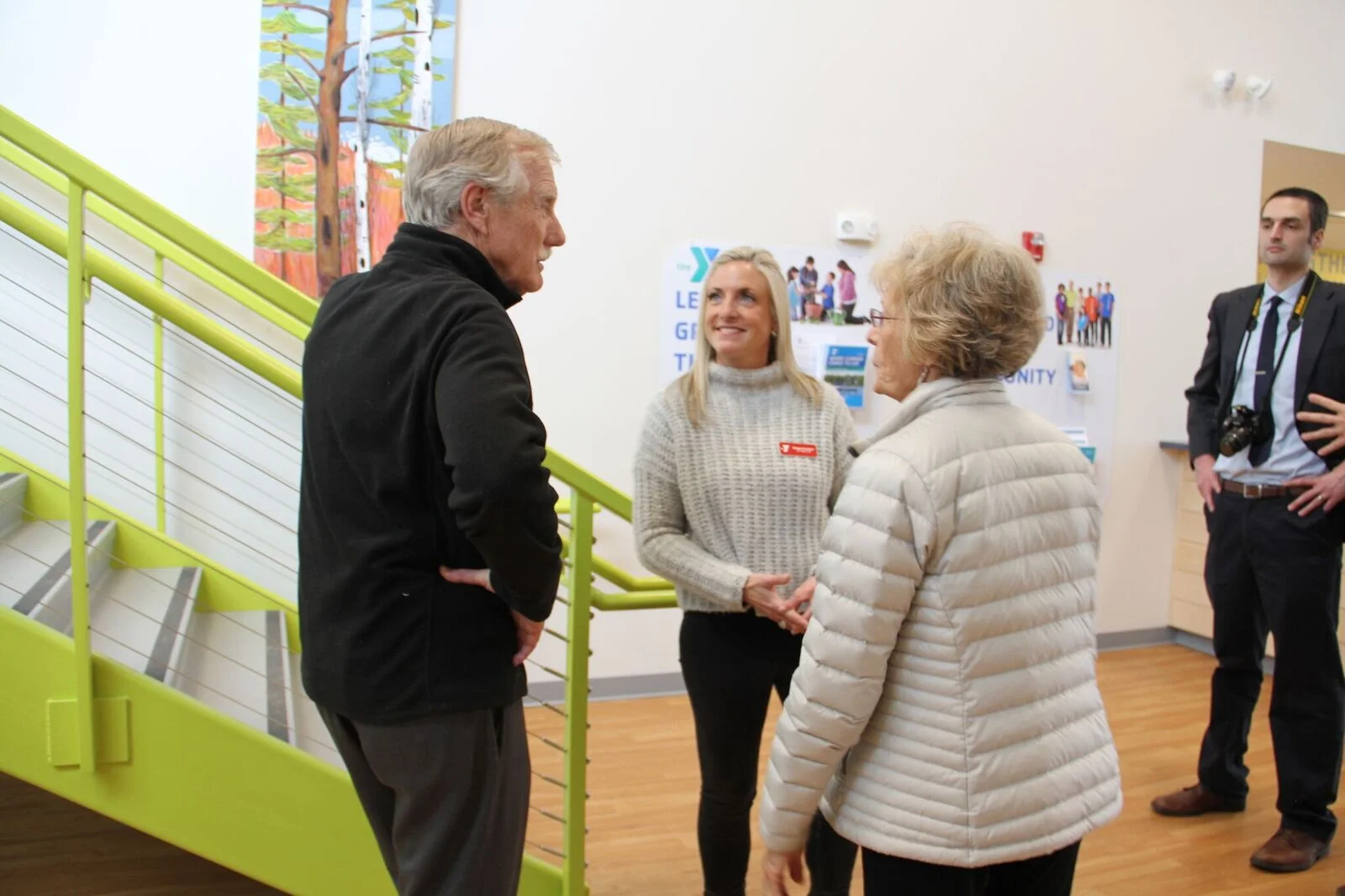 Senator Angus King of Maine, the YMCA's CEO Meagan Hamblett and a local artist.