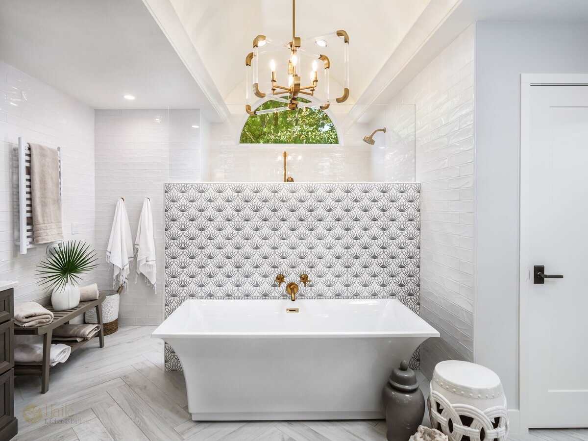 bath design with herringbone tile floor