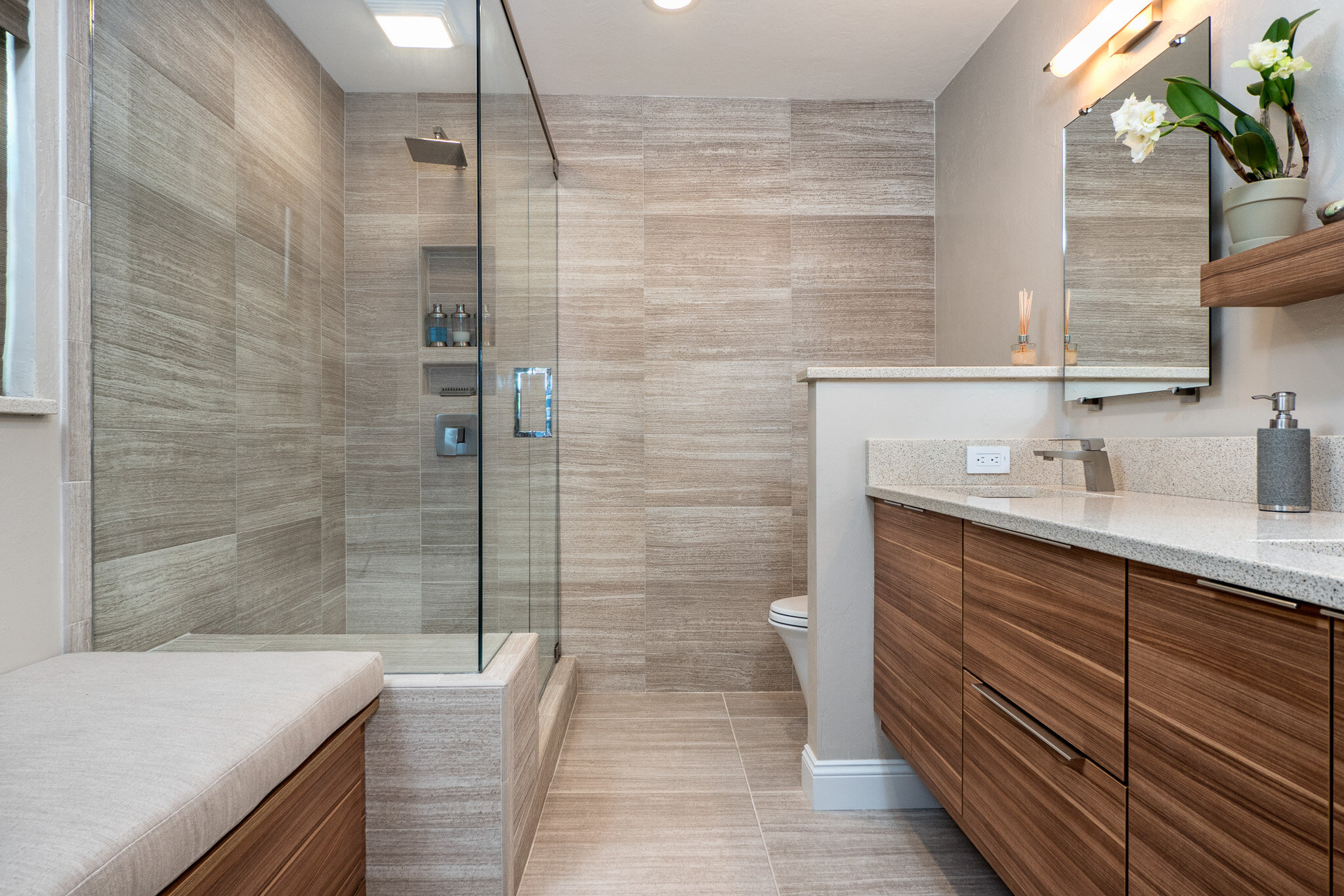 bath design with large format tile and slab cabinetry