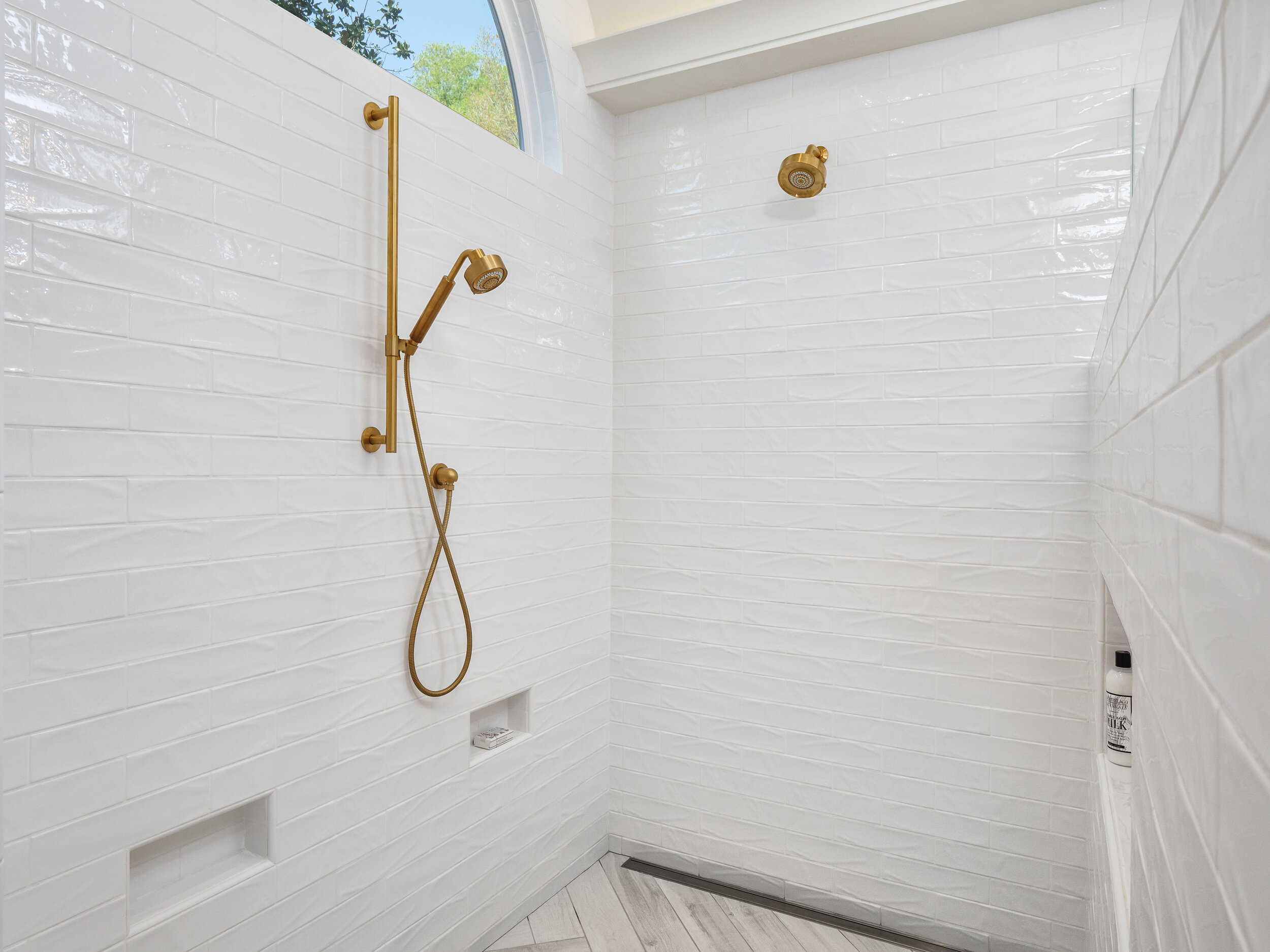 open shower with gold fixtures