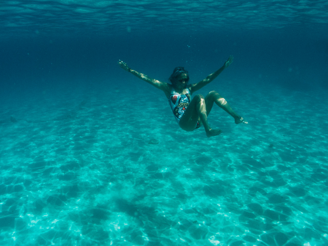 Splashing around the perfect white sand bottom clear blue water at Comino Island.
