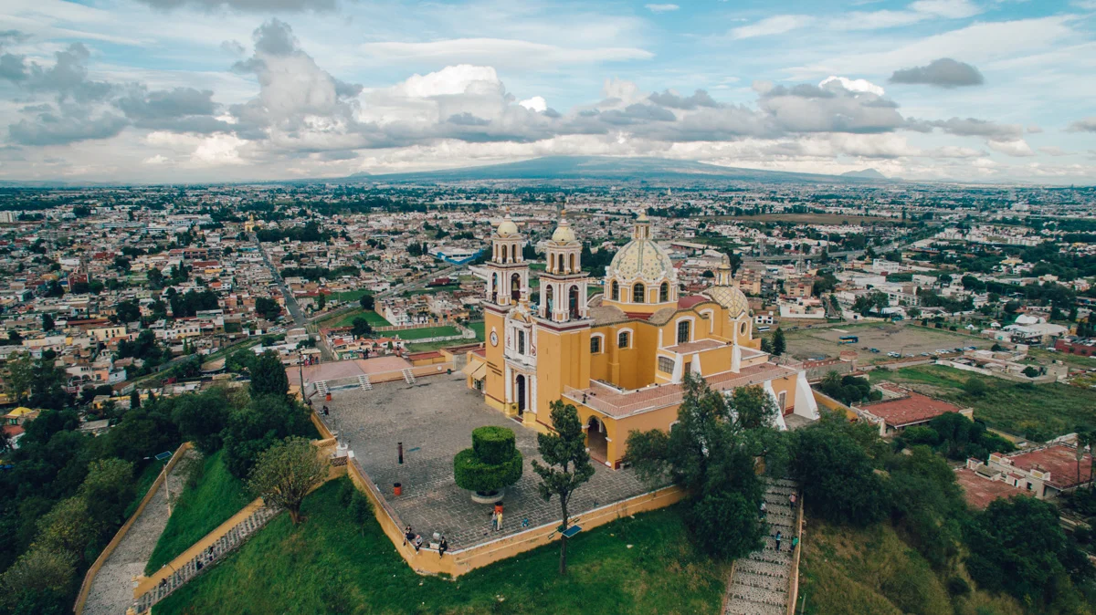 Buried under this church is the largest pyramid (and the largest monument) in the world. This 1500+ year old Aztec pyramid called Tlachihualtepetl is only partially excavated at its base, because the church (Iglesia de Nuestra Señora de los Remedios) built 400 years ago continues to be an important landmark and place of worship for Catholics today.