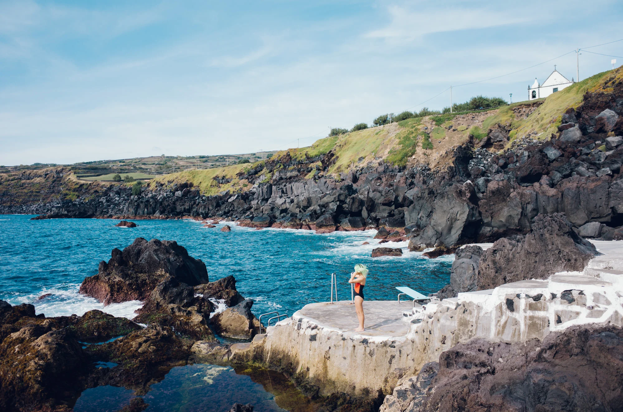 Taking a frigid dip at the rock pools at Cinco Riberas.