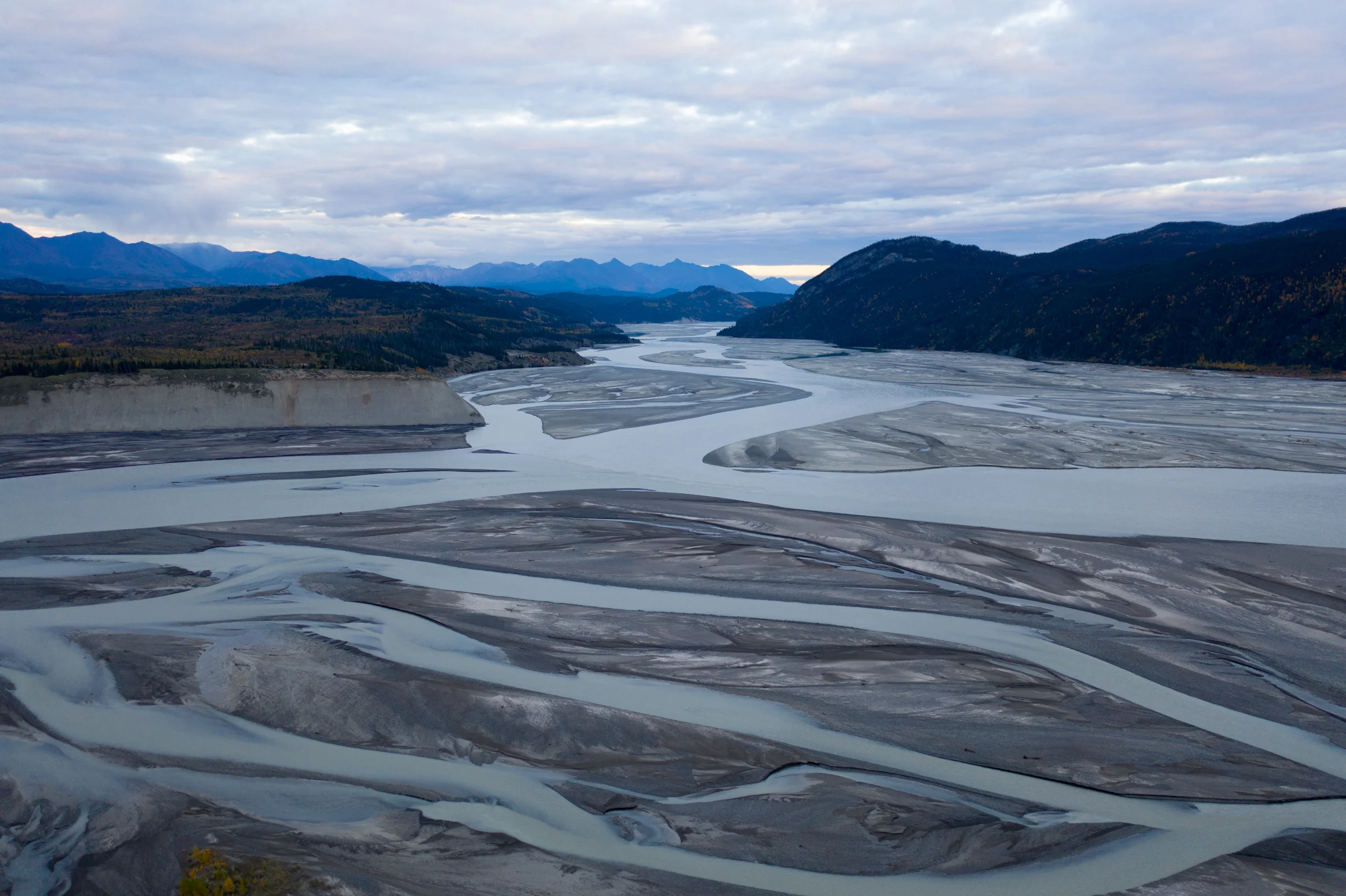 Drone shot looking down the milky glacier-fed Copper River into Wrangell-St. Elias National Park.