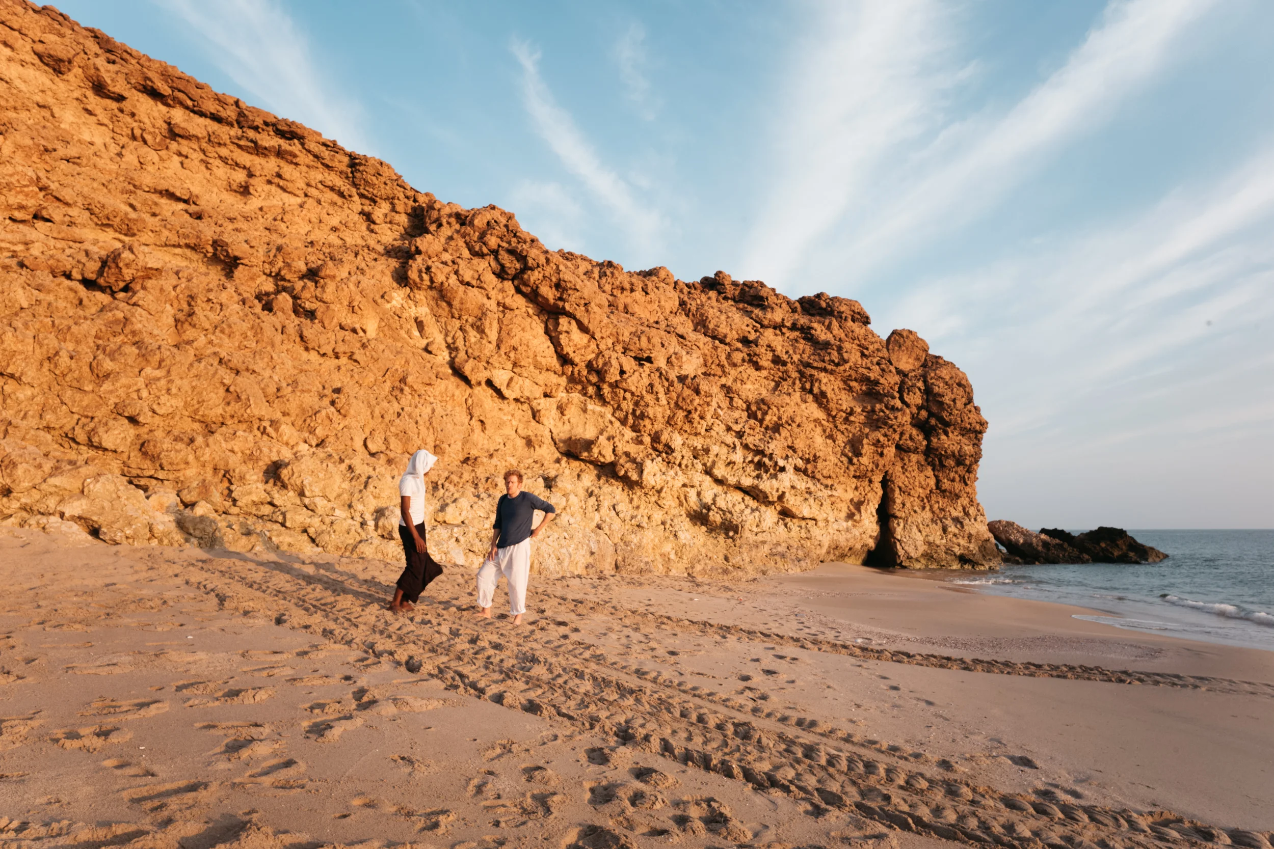 David and a local boy on the beach. Around them are the tracks of sea turtles that had come to nest in the night.