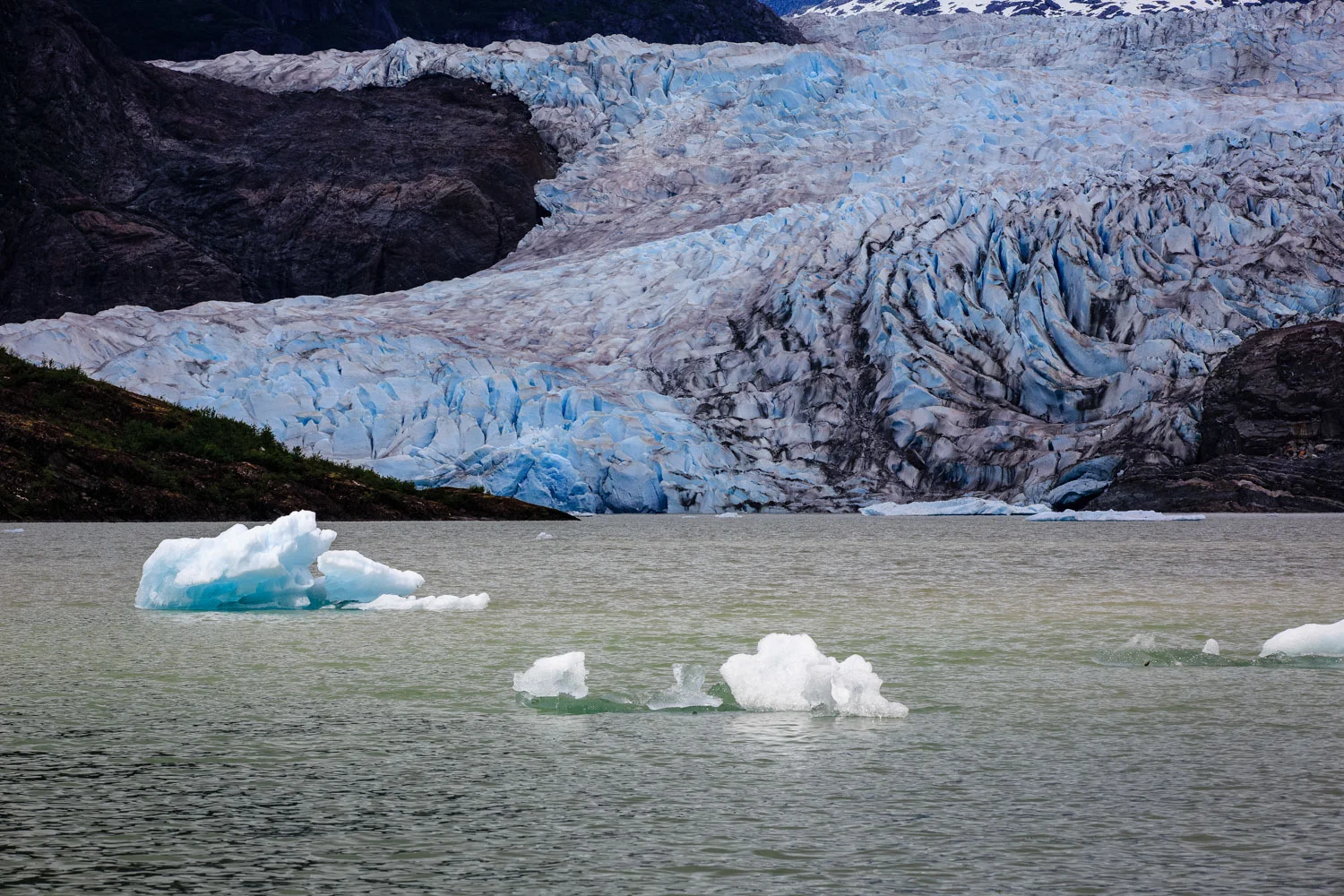 Bride and the groom kayaking out to the face of the glacier