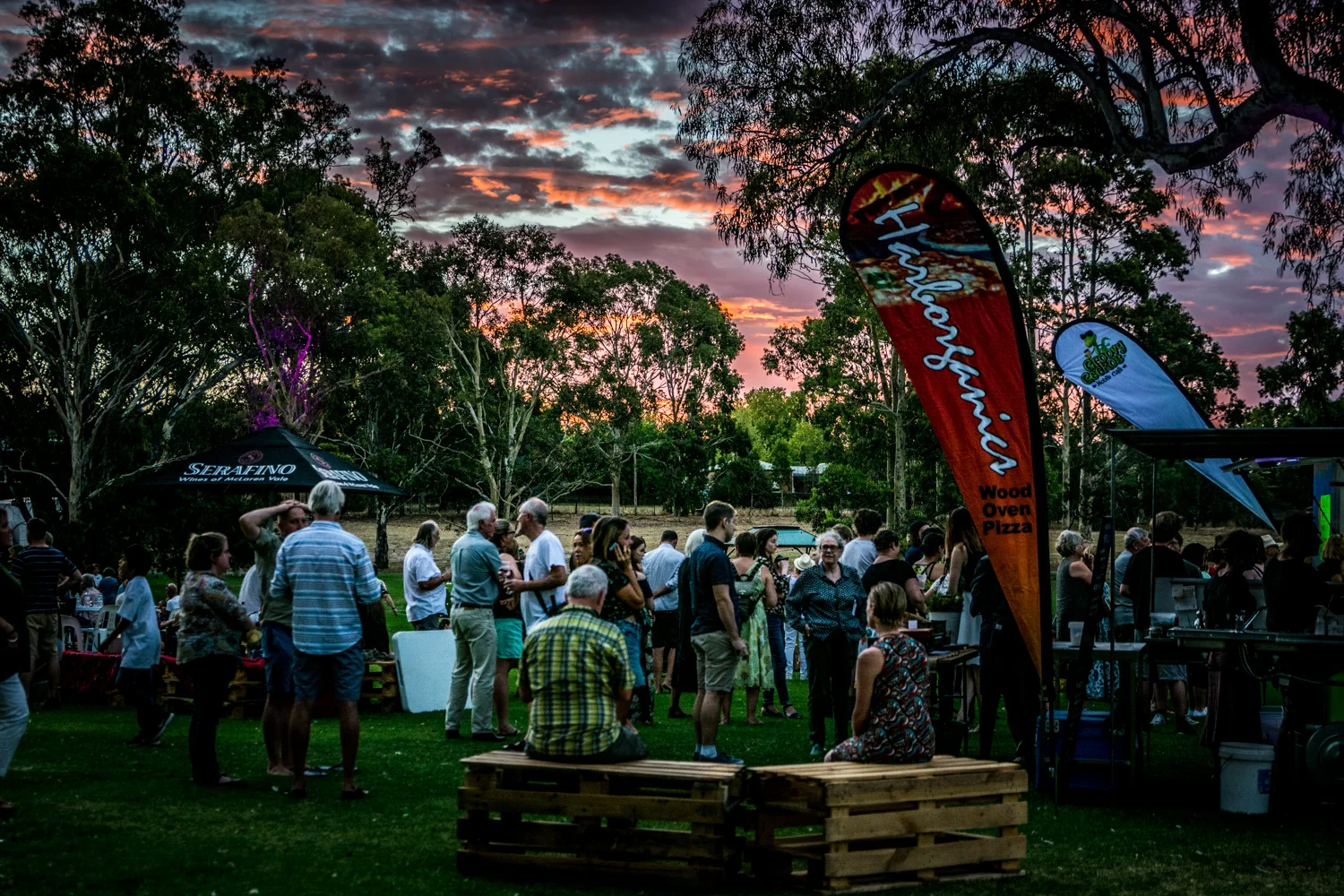Crowds gather as the sun sets