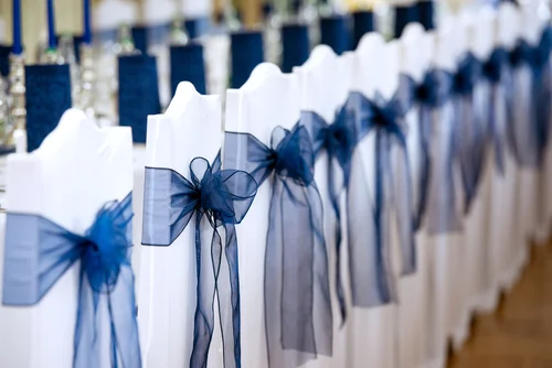 white lycra chair cover with navy organza sash