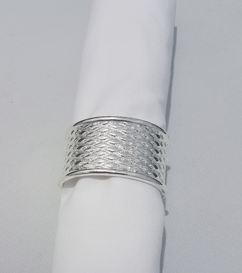 silver textured napkin ring with white rolled napkin