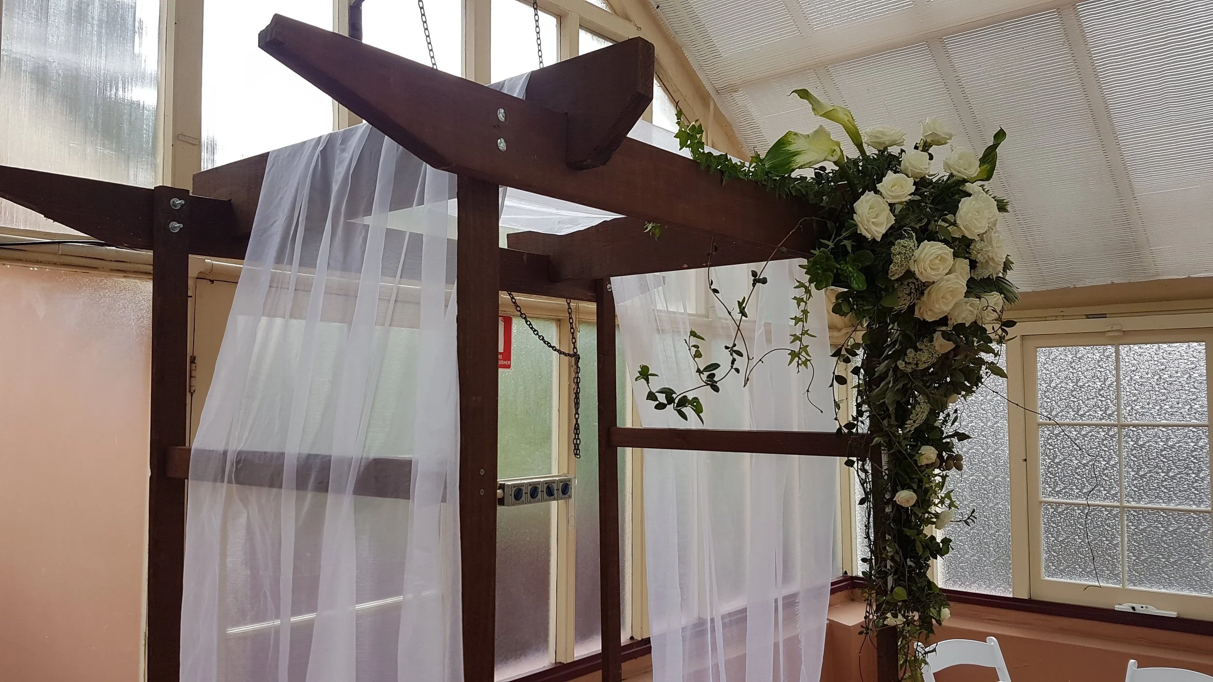 timber-wedding-ceremony-arch-with-florals.jpg