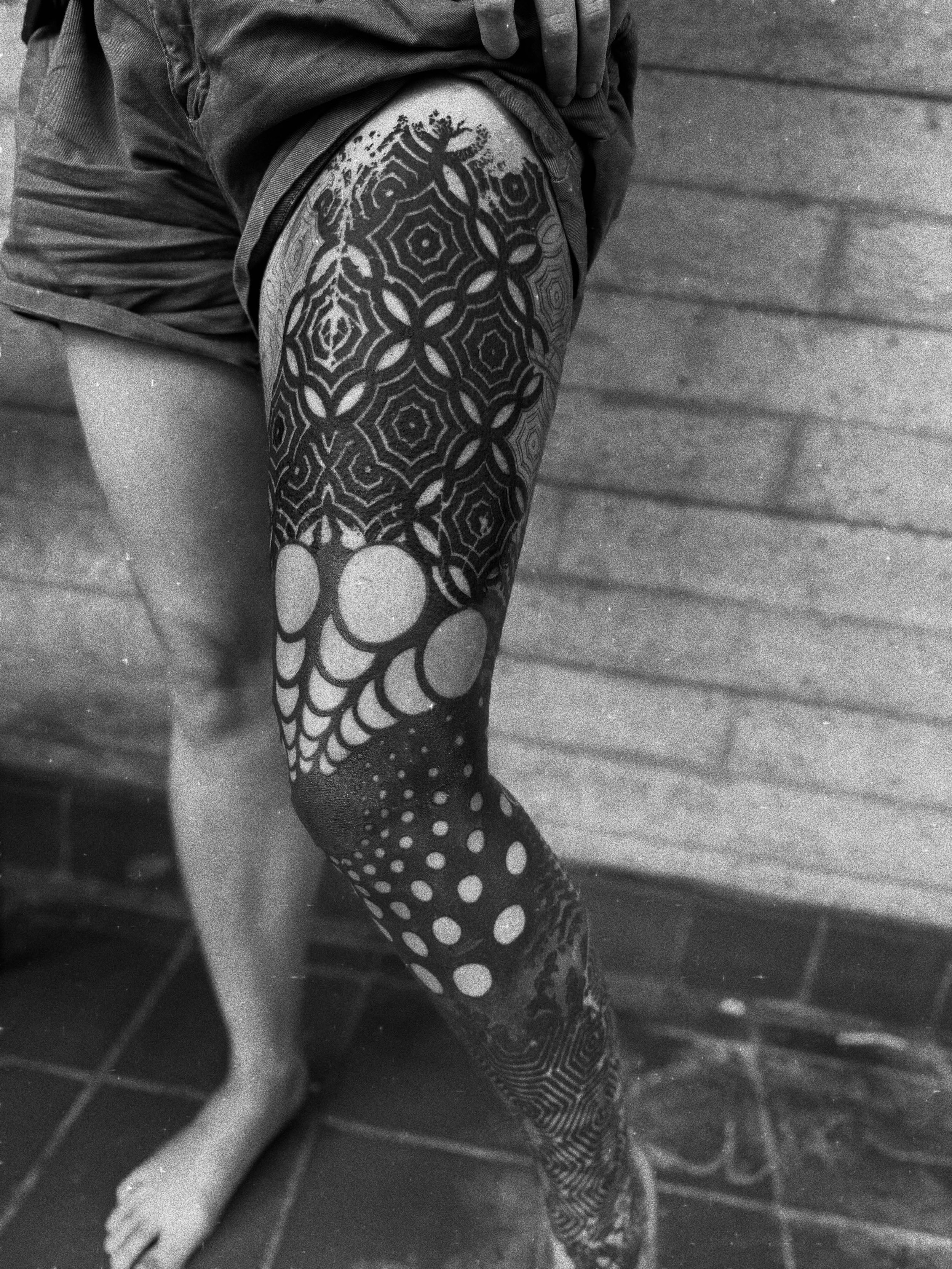 Big abstract black geometry leg by @dotworkboss. Ash is now taking bookings for August