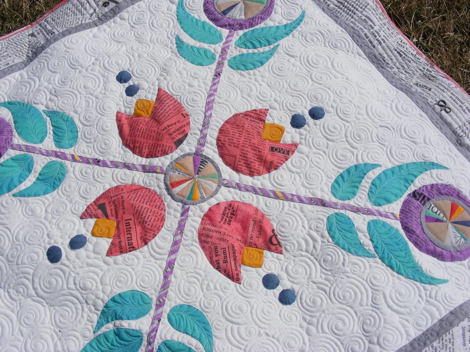 Colorful quilt with floral and leaf patterns